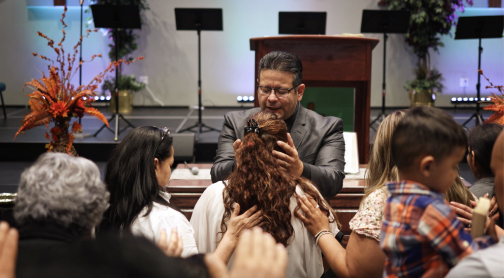 Pastor Juan praying at Esperanza Viva